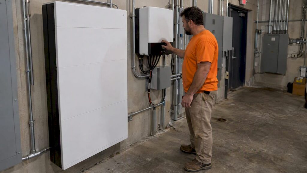 Installer checks a commercial battery inverter