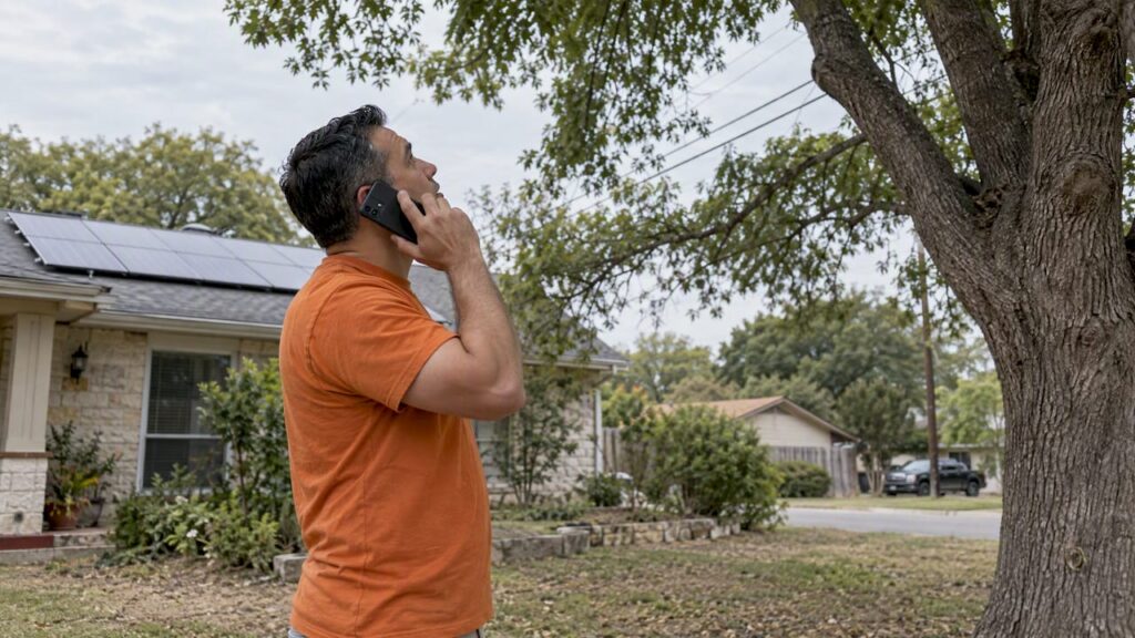 Homeowner calling CPS beneath a tree